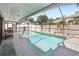 A large screened in in-ground pool and patio at 852 Crystal Dr, Palm Harbor, FL 34683