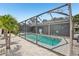 Inviting screened-in pool area with lovely stone accents and lush tropical landscaping offers a relaxing outdoor retreat at 852 Crystal Dr, Palm Harbor, FL 34683