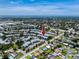 Condo complex in an aerial view near a body of water, lush greenery, and residential streets at 8584 111Th St # 308, Seminole, FL 33772