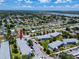 Aerial view of a well-situated condominium complex surrounded by mature trees and residential housing at 8584 111Th St # 308, Seminole, FL 33772