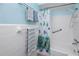 Bright bathroom with a shower/tub combination and sea-themed accents at 8584 111Th St # 308, Seminole, FL 33772