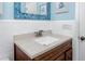 Neat bathroom showcases a wood vanity, a decorative mirror, and elegant blue accents at 8584 111Th St # 308, Seminole, FL 33772