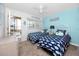 Bright bedroom featuring two beds, blue accents, and a screened in patio beyond the sliding doors at 8584 111Th St # 308, Seminole, FL 33772