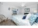 Serene bedroom featuring a comfortable bed with patterned bedding, a ceiling fan, and charming decor at 8584 111Th St # 308, Seminole, FL 33772