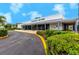Peacock Center clubhouse exterior with well-maintained landscaping and ample parking at 8584 111Th St # 308, Seminole, FL 33772