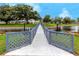 Scenic bridge leading to a charming community featuring lush greenery and tranquil water views under a blue sky at 8584 111Th St # 308, Seminole, FL 33772