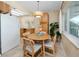 Charming dining area with a round table, seating for four, and a view from the window at 8584 111Th St # 308, Seminole, FL 33772