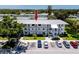 Well-maintained condominium building with manicured landscaping, ample parking, and a welcoming entrance area at 8584 111Th St # 308, Seminole, FL 33772