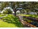 Expansive green space featuring mature trees, walking path, and a water feature at 8584 111Th St # 308, Seminole, FL 33772