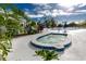 Community hot tub with surrounding landscaping, tables, and seating areas at 8584 111Th St # 308, Seminole, FL 33772