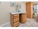 Kitchen area with natural wood cabinetry, countertop decor, and adjacent dining area at 8584 111Th St # 308, Seminole, FL 33772