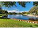 Scenic lake view with well-maintained green grass and retaining walls at 8584 111Th St # 308, Seminole, FL 33772