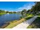 Scenic lake with fountain, sidewalk, and lush landscaping near apartment buildings at 8584 111Th St # 308, Seminole, FL 33772
