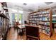 Cozy library room with bookshelves, seating, and a pool table in the background at 8584 111Th St # 308, Seminole, FL 33772