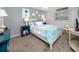 Charming bedroom with cool tones, blue accents and a decorative headboard at 8584 111Th St # 308, Seminole, FL 33772