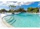 Community pool area with sparkling water and ample seating under sunny skies at 8584 111Th St # 308, Seminole, FL 33772