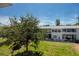 Enjoy the view from the screened lanai showcasing lush greenery and the building's exterior at 8584 111Th St # 308, Seminole, FL 33772