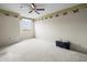 Carpeted bedroom with neutral paint, fan and window at 8731 Huntfield St, Tampa, FL 33635