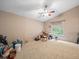 Bedroom with carpet flooring, fan, and window providing natural light at 8731 Huntfield St, Tampa, FL 33635