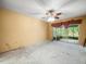 A bedroom featuring a ceiling fan and light, and a sliding glass door that accesses the backyard at 8731 Huntfield St, Tampa, FL 33635
