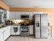 Functional kitchen featuring stainless steel appliances and white cabinetry at 8731 Huntfield St, Tampa, FL 33635