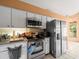 Well-equipped kitchen with a stainless steel refrigerator and a view to a window at 8731 Huntfield St, Tampa, FL 33635
