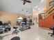 Spacious living room with tile floors, ceiling fan, and view of the staircase at 8731 Huntfield St, Tampa, FL 33635