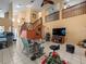 Expansive living area with a fireplace, open staircase, and lots of natural light at 8731 Huntfield St, Tampa, FL 33635