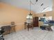 Bright living room area with tile flooring, table, and home entertainment at 8731 Huntfield St, Tampa, FL 33635