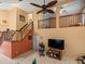Open-concept living area showcasing staircase, ceiling fan, and tile floor at 8731 Huntfield St, Tampa, FL 33635