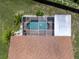Overhead shot of a screened-in pool with clear water, attached to a well-maintained home at 9702 Mary Robin Dr, Riverview, FL 33569
