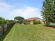 Spacious backyard with a screen enclosed patio, a fenced yard, and lush green grass at 9702 Mary Robin Dr, Riverview, FL 33569