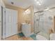 Bathroom boasts a white vanity, a decorative mirror, and a walk-in shower with marble surround at 9702 Mary Robin Dr, Riverview, FL 33569