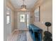 Welcoming entryway featuring a decorative light fixture and stylish console table at 9702 Mary Robin Dr, Riverview, FL 33569