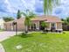 Lovely single-story home with green lawn and ample space between tropical landscaping at 9702 Mary Robin Dr, Riverview, FL 33569