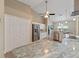 Bright kitchen featuring stainless steel appliances, granite countertops, and a vaulted ceiling with a ceiling fan at 9702 Mary Robin Dr, Riverview, FL 33569