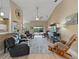 Spacious living room with vaulted ceilings, fan and sliding doors to pool at 9702 Mary Robin Dr, Riverview, FL 33569