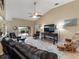 Bright living room featuring ceiling fan and sliding doors to the pool and outdoor living space at 9702 Mary Robin Dr, Riverview, FL 33569