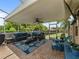 Covered patio area with comfortable seating, brick flooring, and a view of the backyard through the screen at 9702 Mary Robin Dr, Riverview, FL 33569
