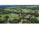 Aerial view of neighborhood highlighting the treed property and surrounding landscape at 1110 Mercer Loop, Plant City, FL 33567