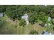 Wide shot of property showing home, surrounded by mature trees on large lot at 1110 Mercer Loop, Plant City, FL 33567
