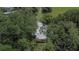 Aerial view of the house featuring mature trees surrounding the house and a metal roof at 1110 Mercer Loop, Plant City, FL 33567