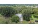 Home exterior with mature trees on a large lot in a suburban setting at 1110 Mercer Loop, Plant City, FL 33567