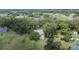 Aerial view of a home nestled among mature trees in a community at 1110 Mercer Loop, Plant City, FL 33567