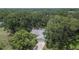 Home exterior with mature trees on a large lot in a suburban setting at 1110 Mercer Loop, Plant City, FL 33567