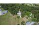 A high angle shot of the treed property surrounded by large green open landscape at 1110 Mercer Loop, Plant City, FL 33567