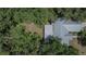 Close up aerial view of the metal roof and the mature trees surrounding the property at 1110 Mercer Loop, Plant City, FL 33567