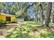 View of the backyard with lush greenery and a detached building at 1110 Mercer Loop, Plant City, FL 33567