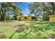 Expansive backyard featuring mature trees and a charming, well-maintained lawn at 1110 Mercer Loop, Plant City, FL 33567