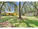 Large backyard featuring mature trees, a house, and a detached garage at 1110 Mercer Loop, Plant City, FL 33567